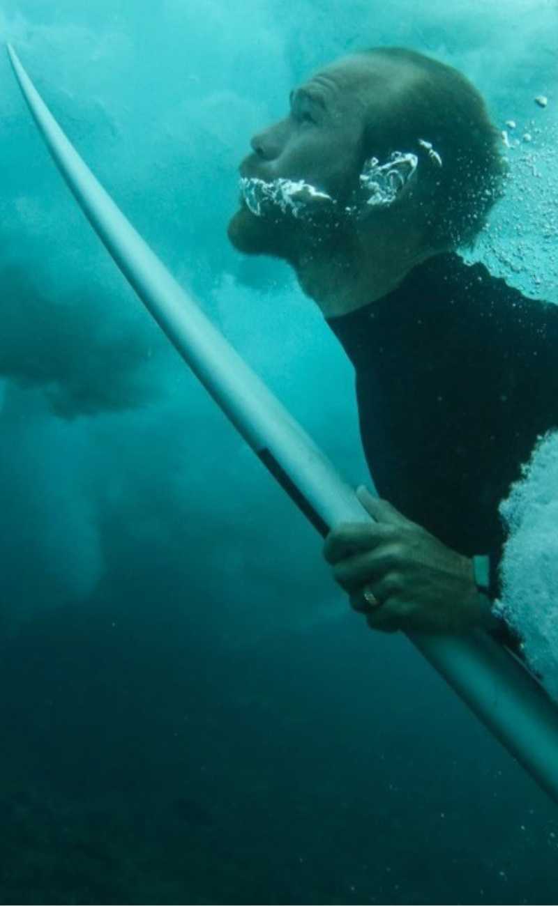 man surfing wearing silicone rings. 