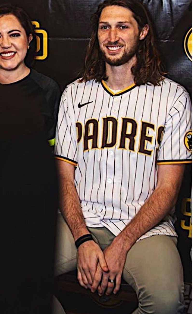 a professional baseball player taking a picture wearing silicone rings.