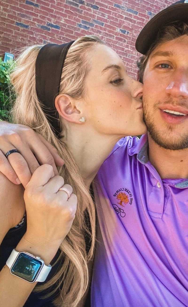 a cute couple holding hands wearing silicone rings.
