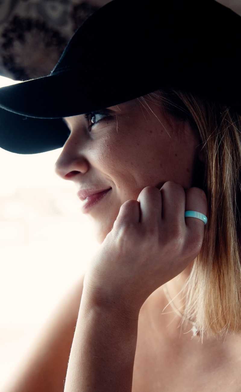 young women smiling wearing a silicone ring. 