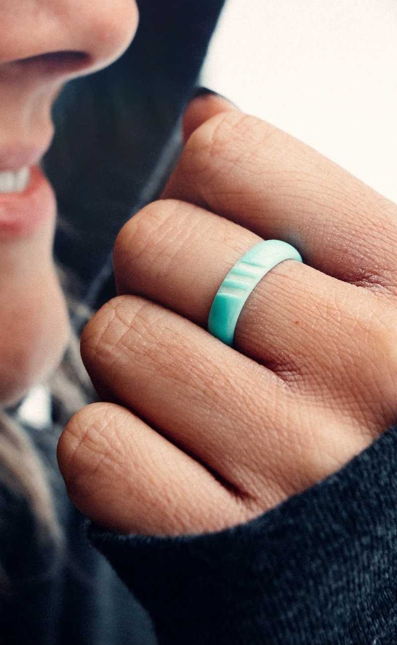 close up picture of a women wearing a silicone ring. 